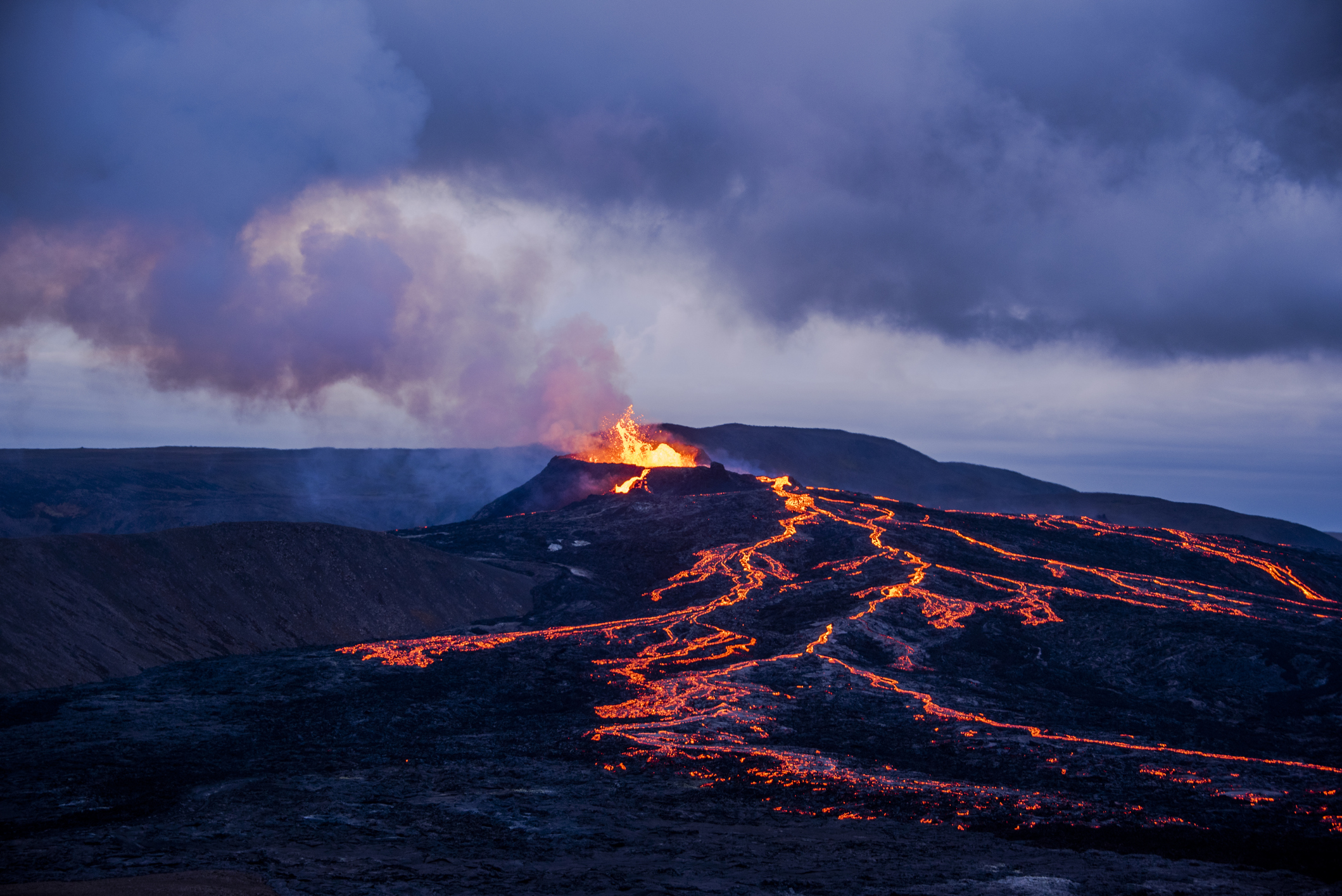 Lavastrømme og Eyjafjallajökull i udbrud i skumringen.